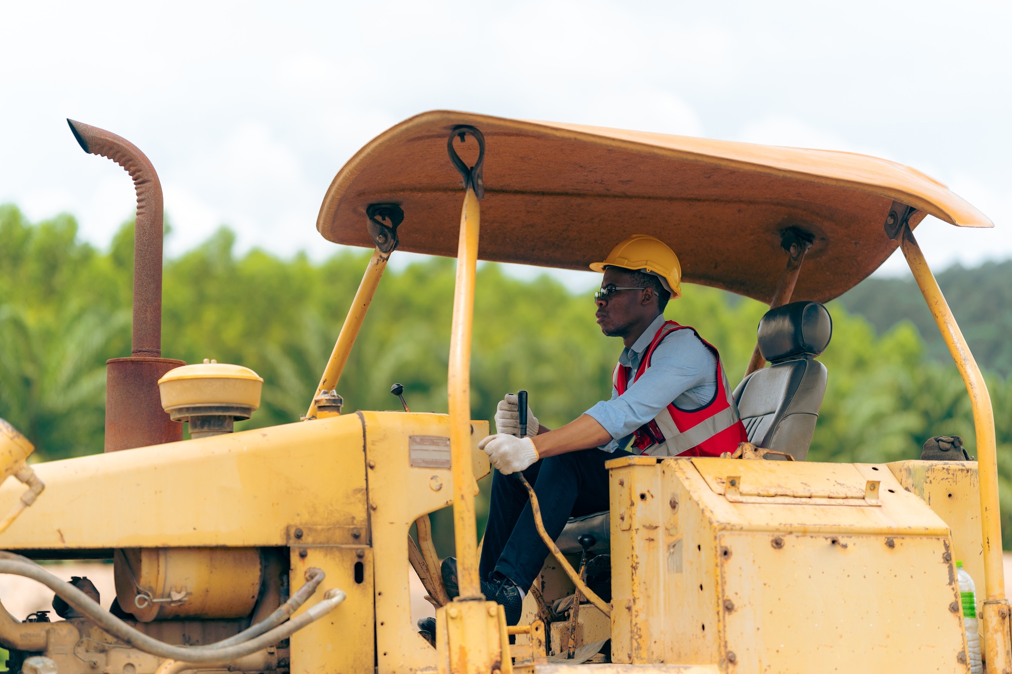 Black people worker in helmet on site construction, Excavator bulldozer male worker